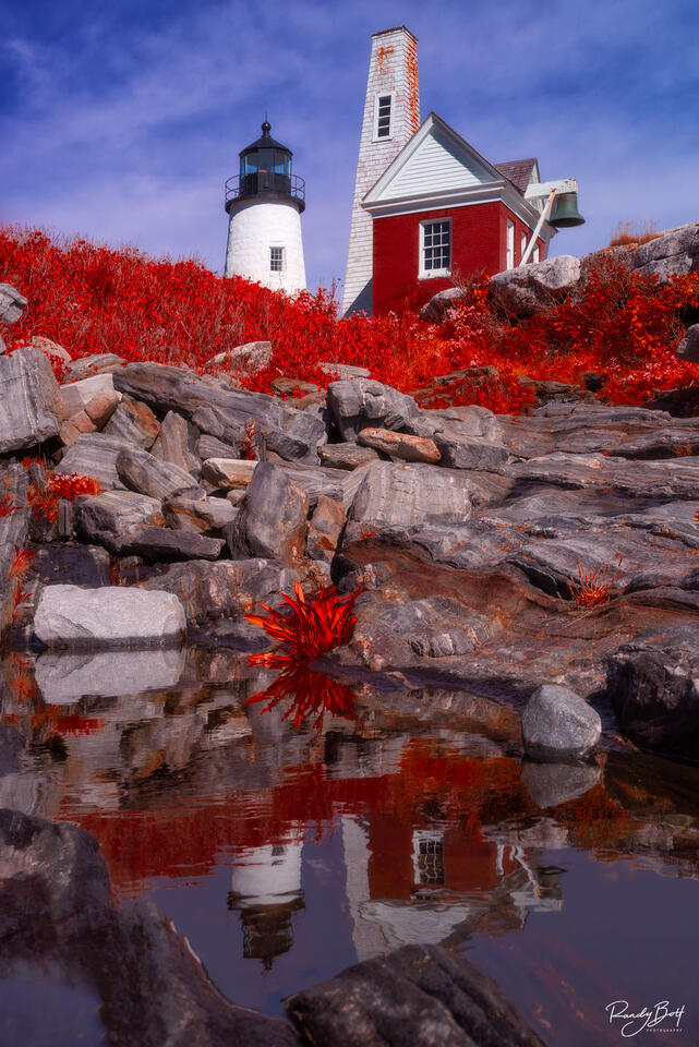 Pemaquid lighthouse in IR chrome infrared reflecting through a small pool of rain water.