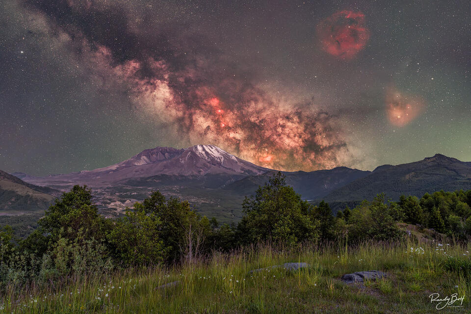Milky Way galaxy shining bright over Mount Saint Helens with 2 nebulas.